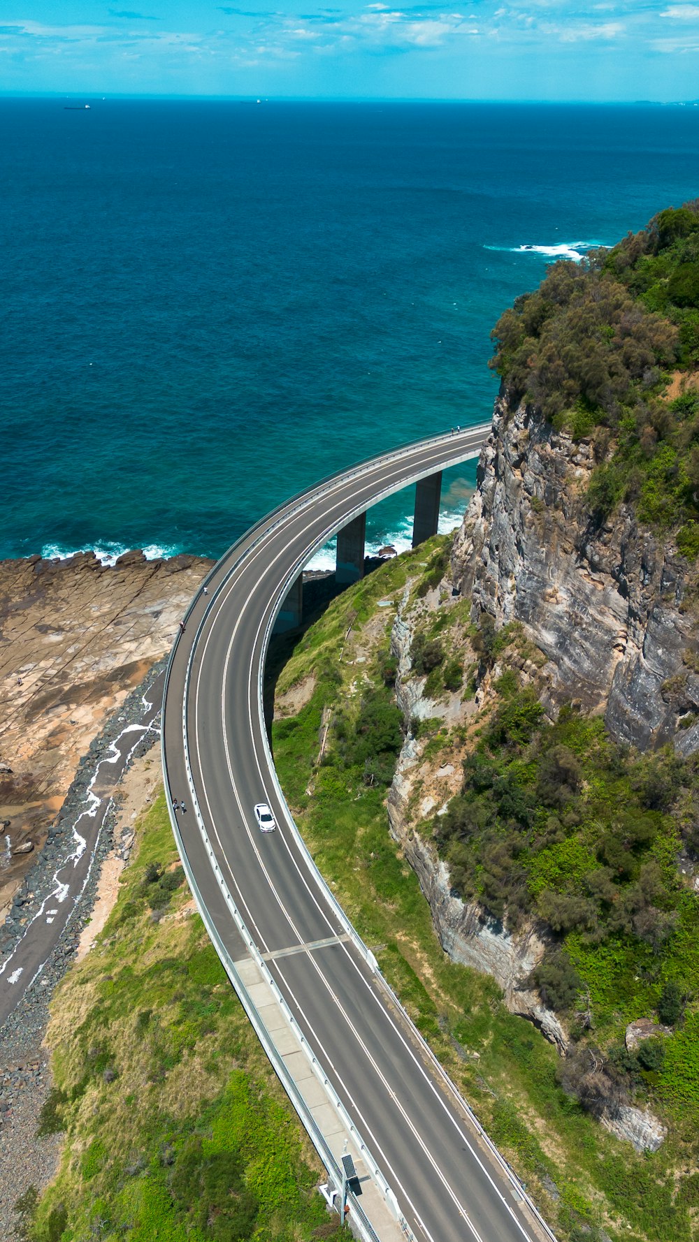 an aerial view of a highway near the ocean