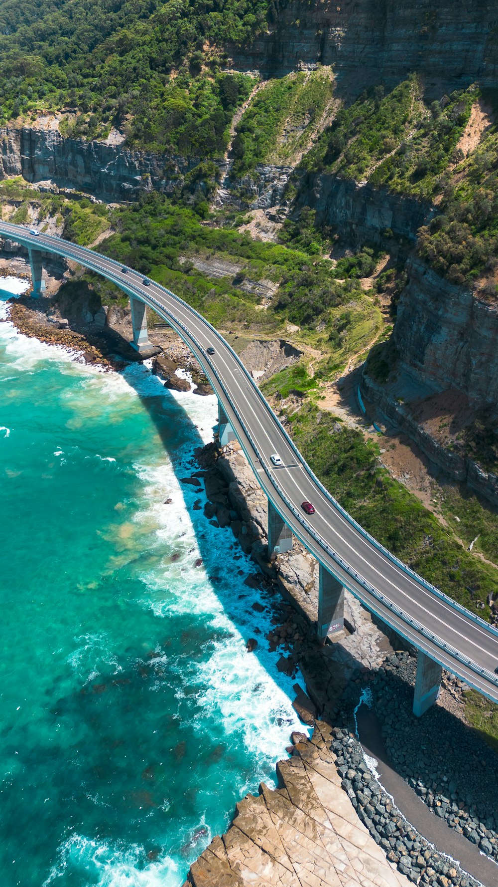 an aerial view of a bridge over a body of water