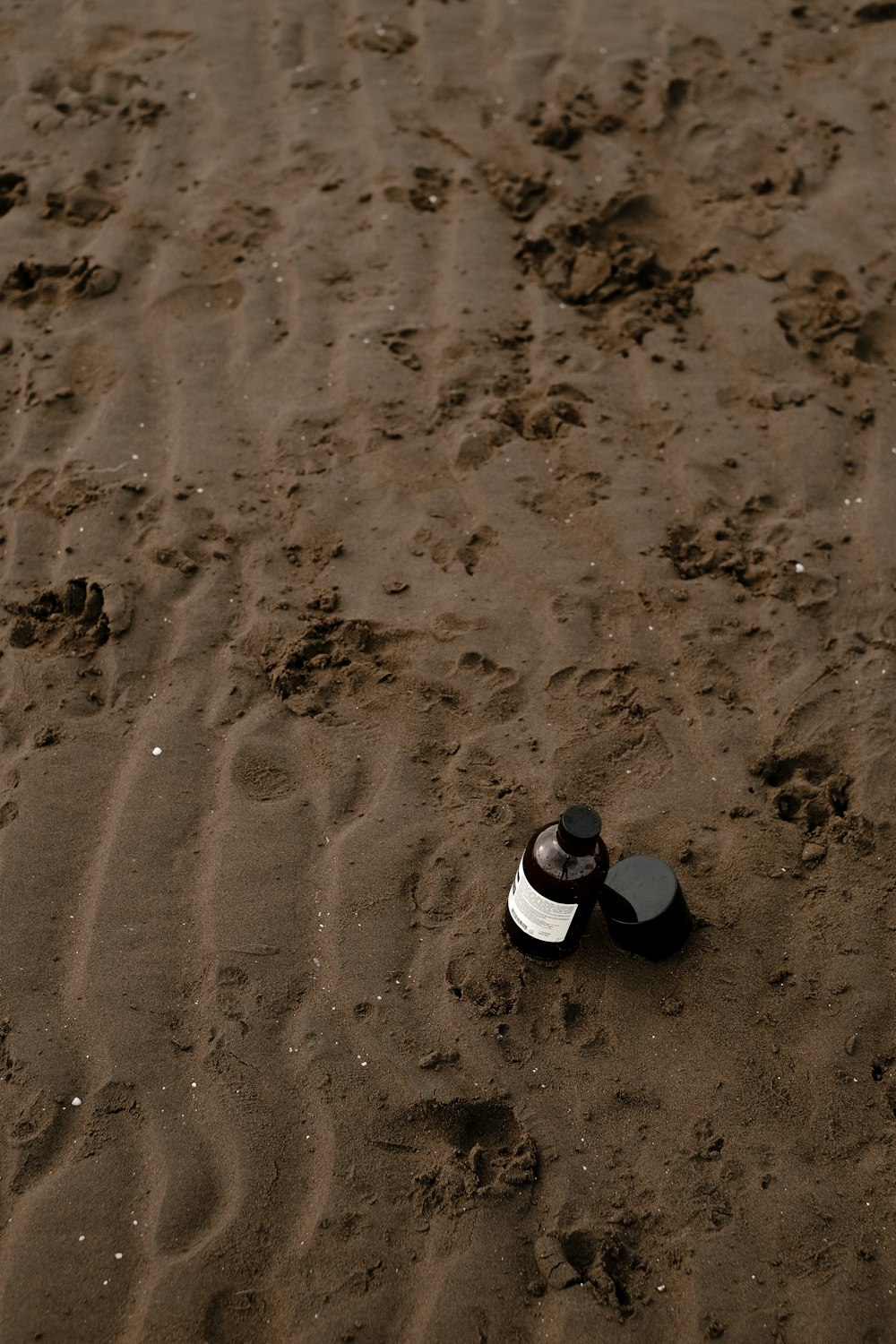 a pair of shoes sitting on top of a sandy beach