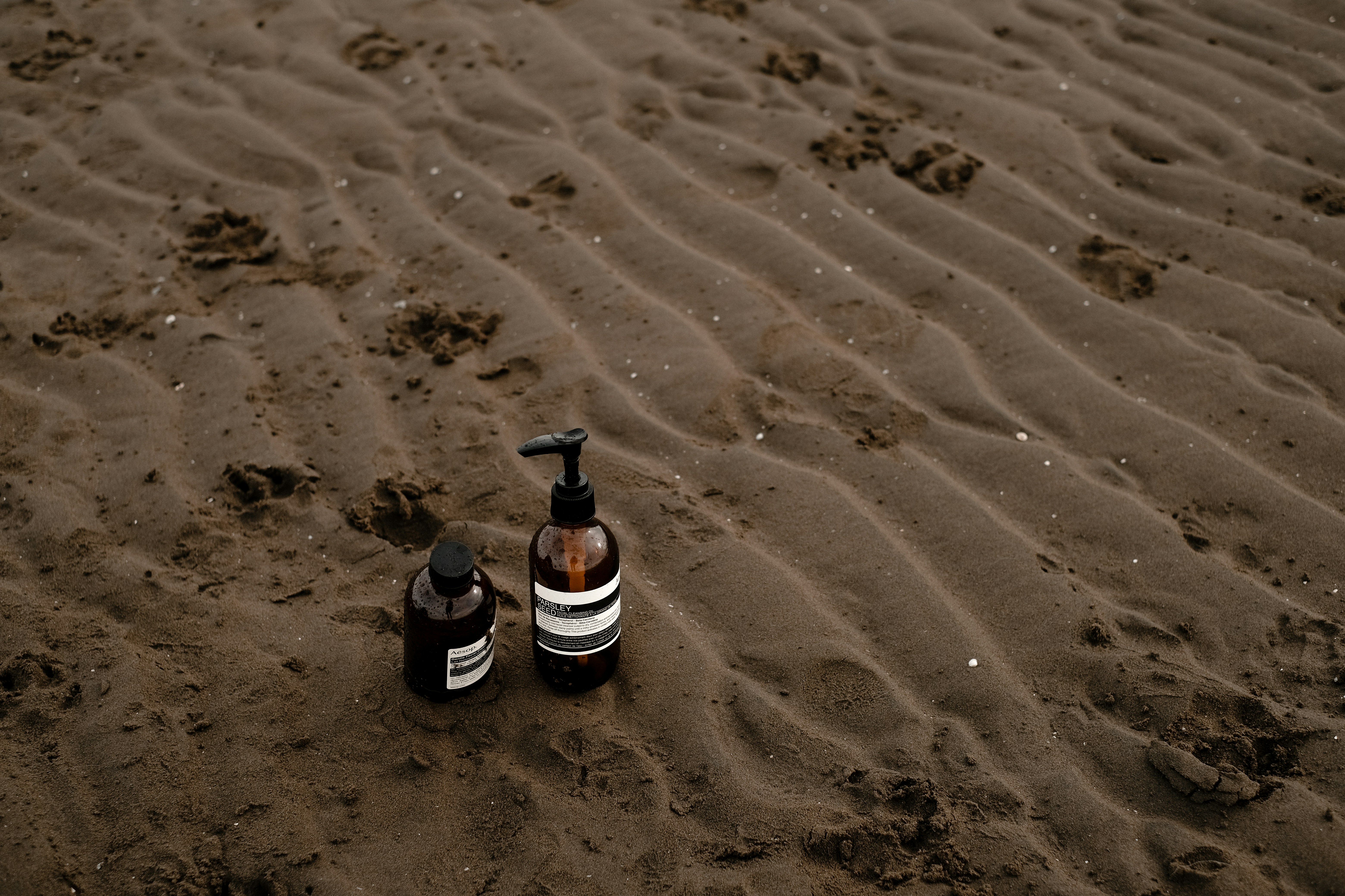 Skincare bottles on beach