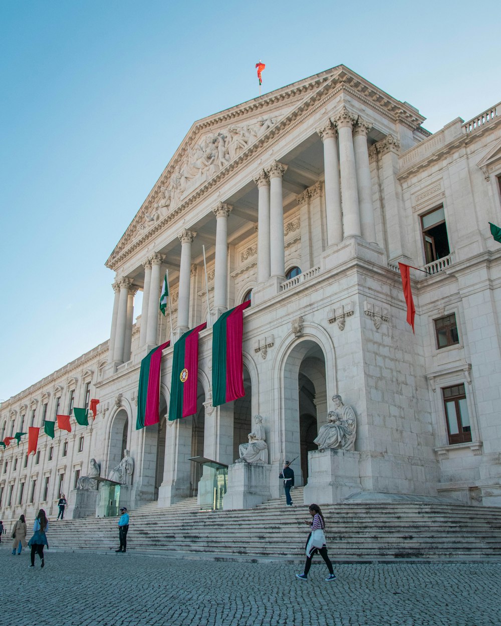 a large white building with many flags on it