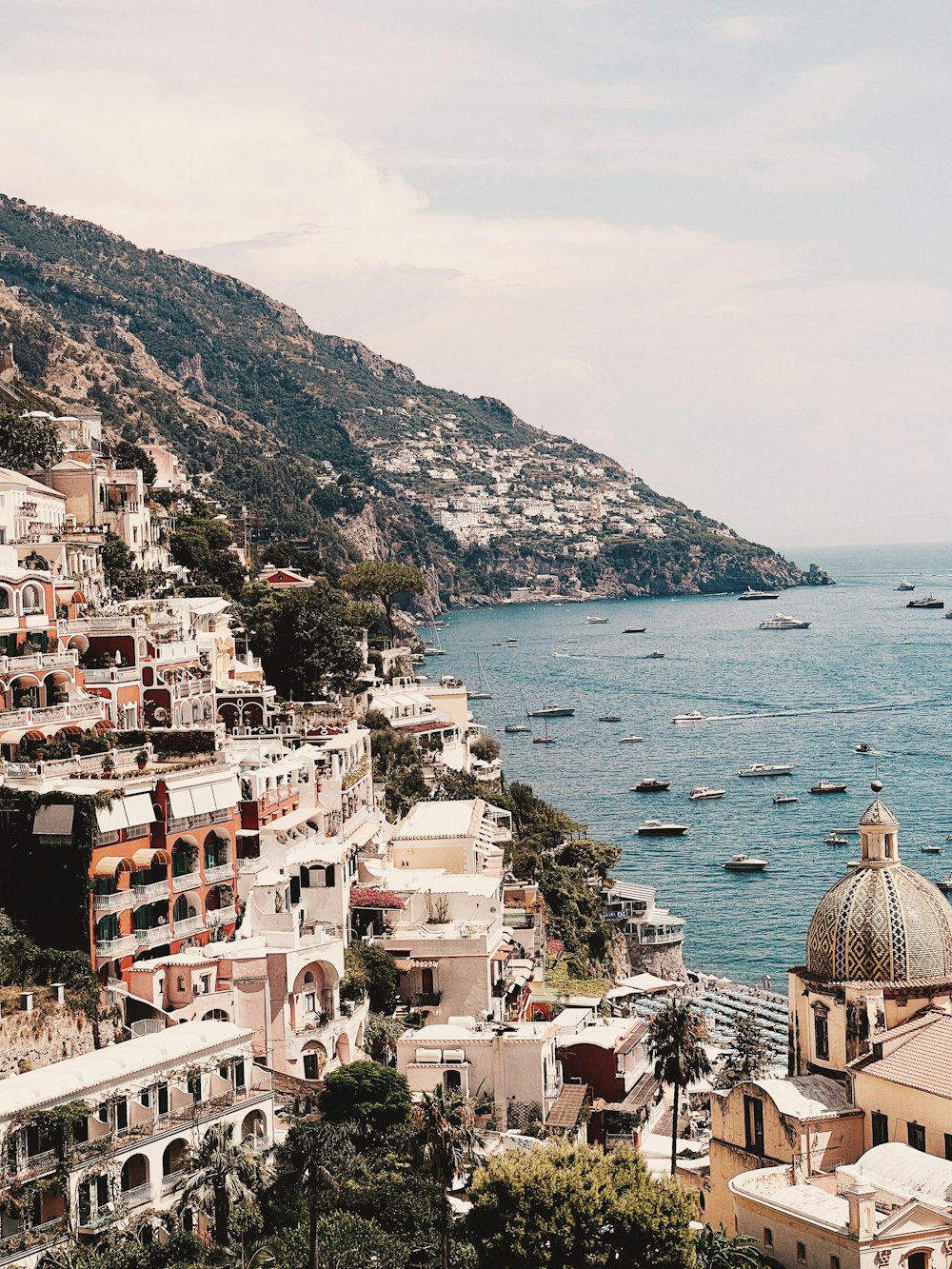 a scenic view of a city next to a body of water