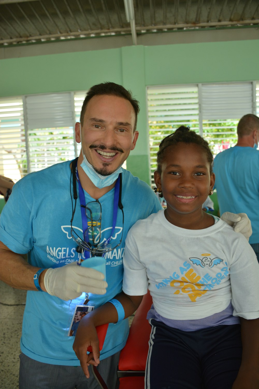 a man standing next to a little girl