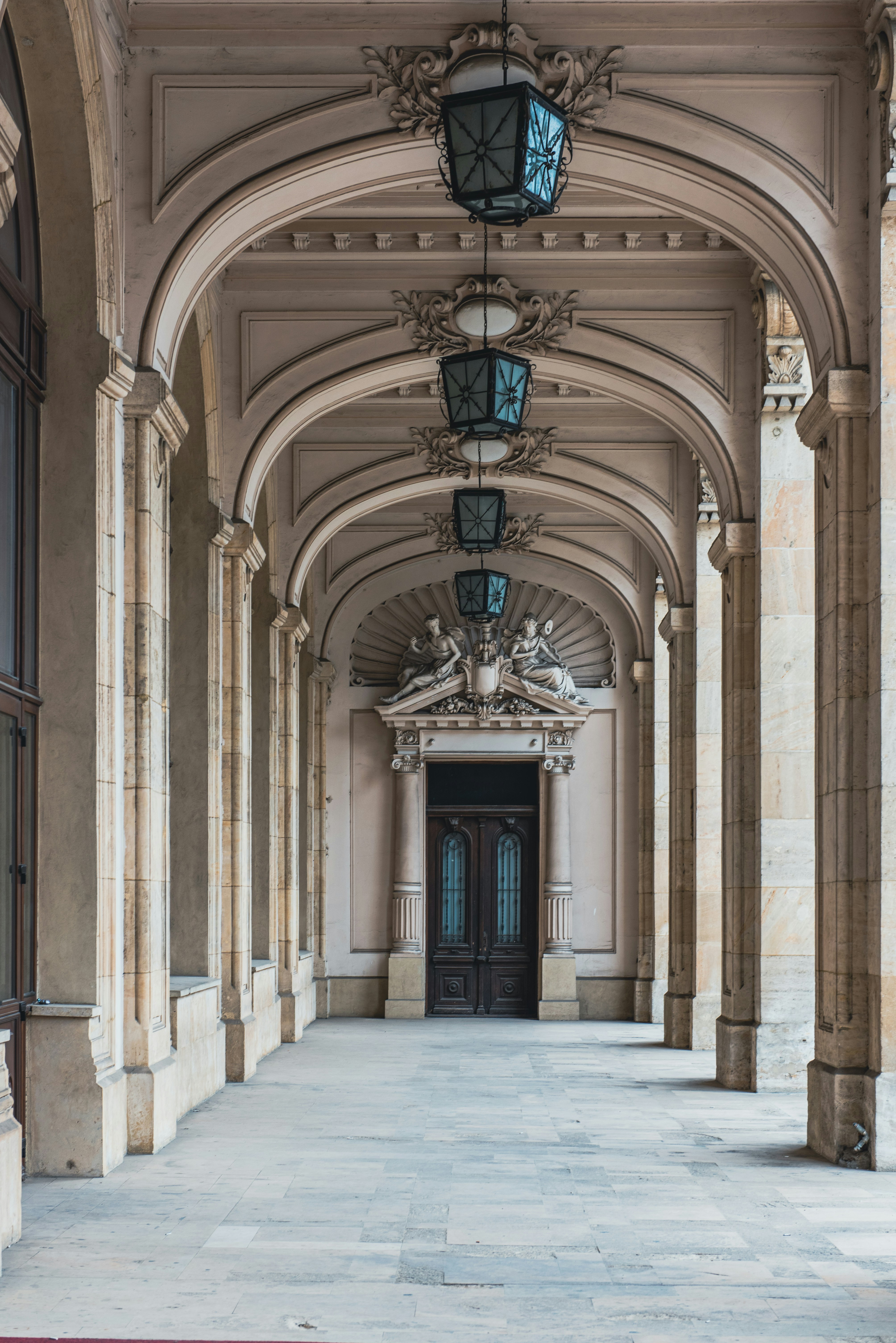 a long hallway with a clock hanging from the ceiling