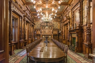 An elegant teakwood table set in a warm, inviting room.