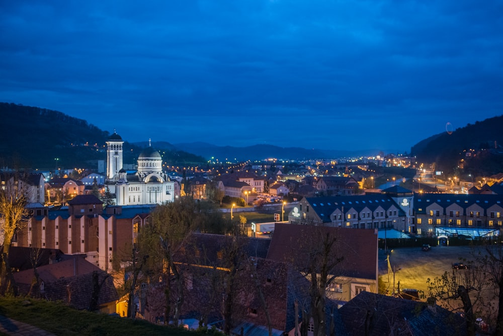 a view of a city at night from a hill