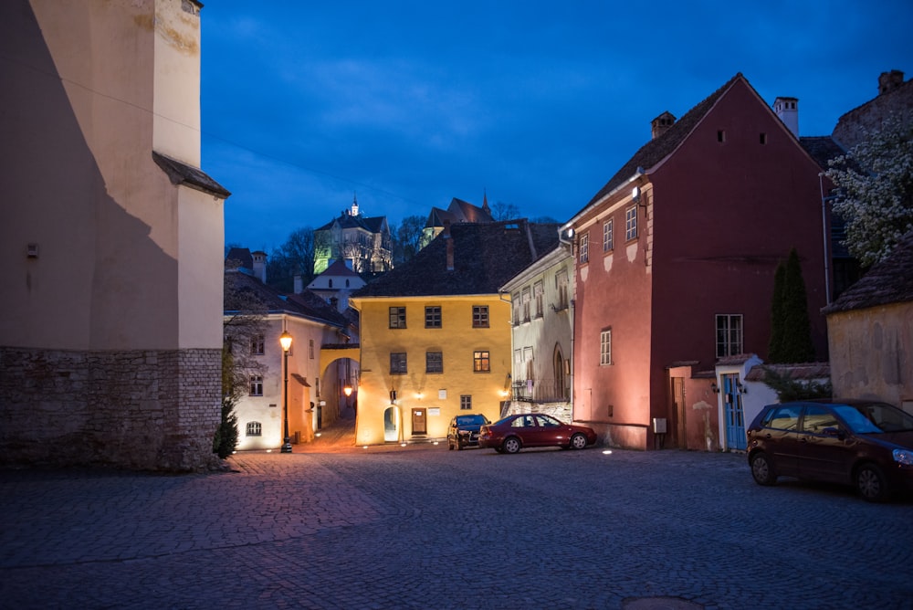 a cobblestone street in a small town at night