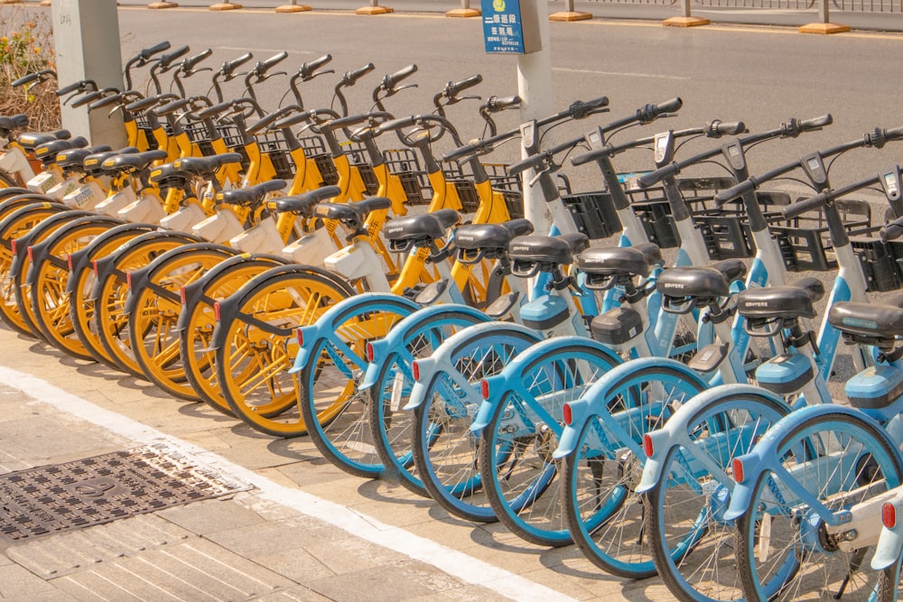 a row of yellow and blue bicycles parked next to each other