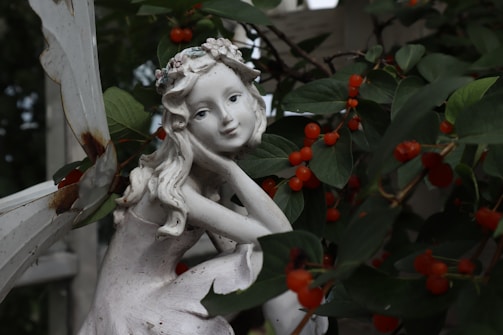 A delicate fairy painted in warm earthy tones, perched on a mushroom in a forest clearing.