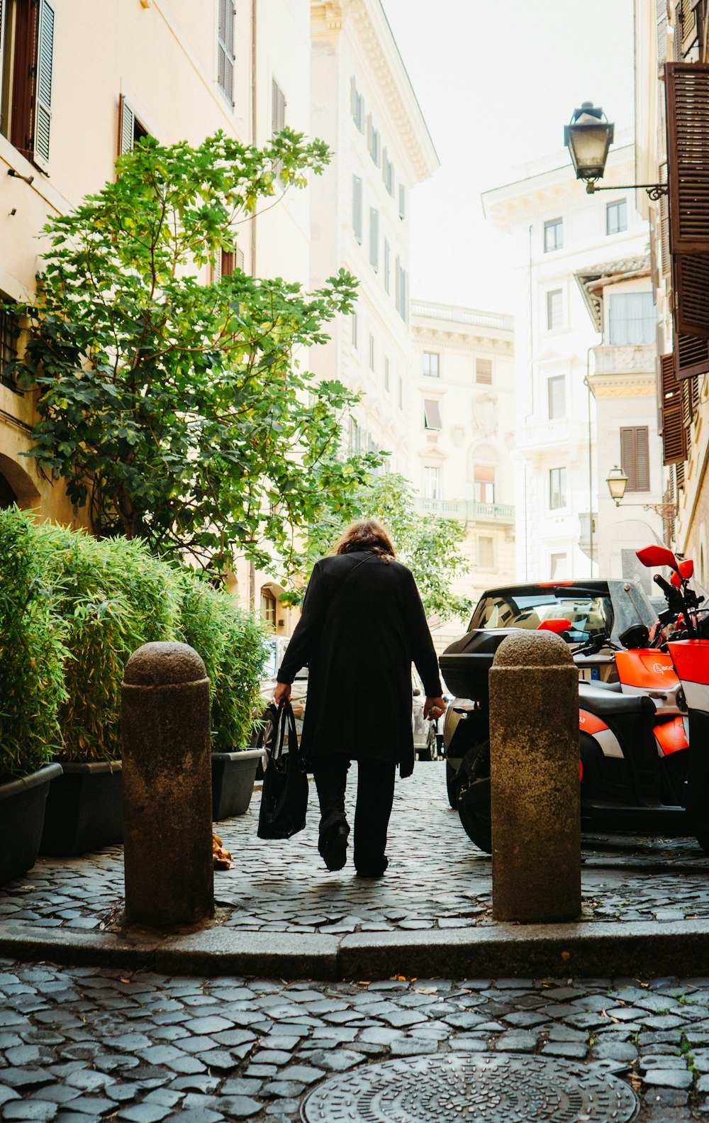 a person walking down a cobblestone street