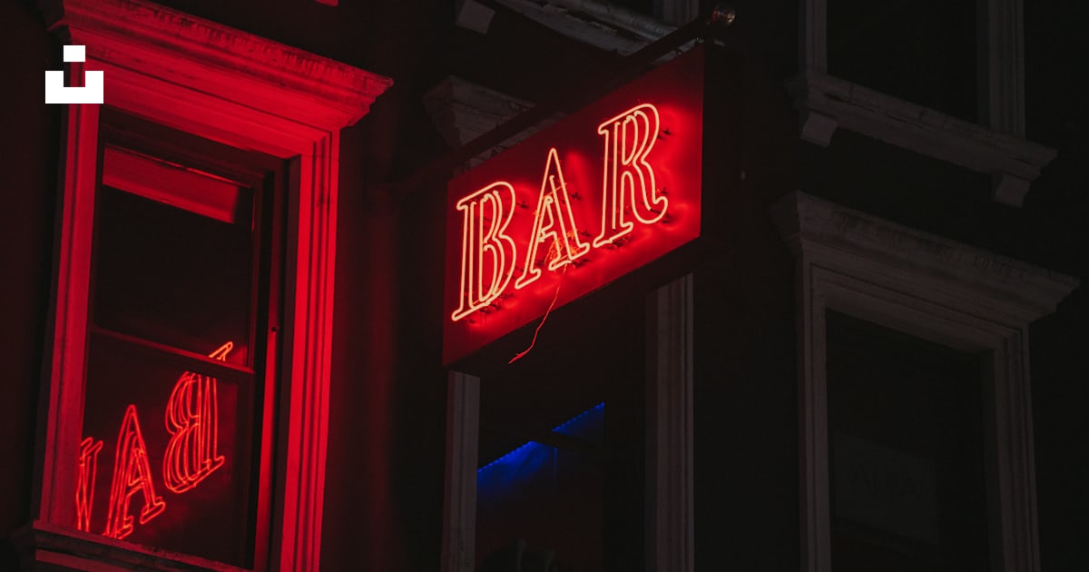 A red bar sign lit up in the dark photo – Free New york Image on Unsplash