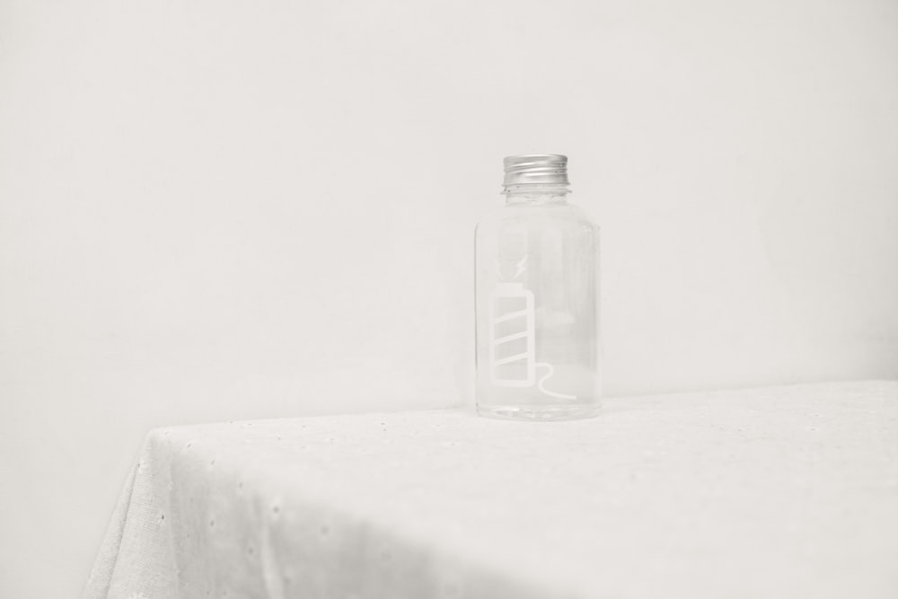 a glass bottle sitting on top of a table