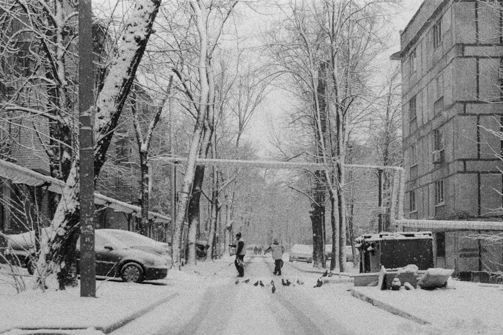 a black and white photo of a snowy street