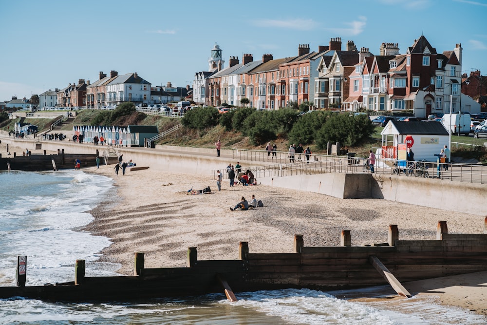 a group of people standing on top of a sandy beach