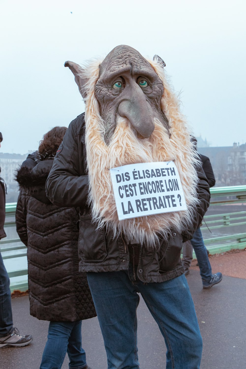 a man in a costume with a sign on his face