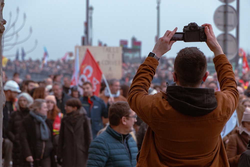a man taking a picture of a crowd of people