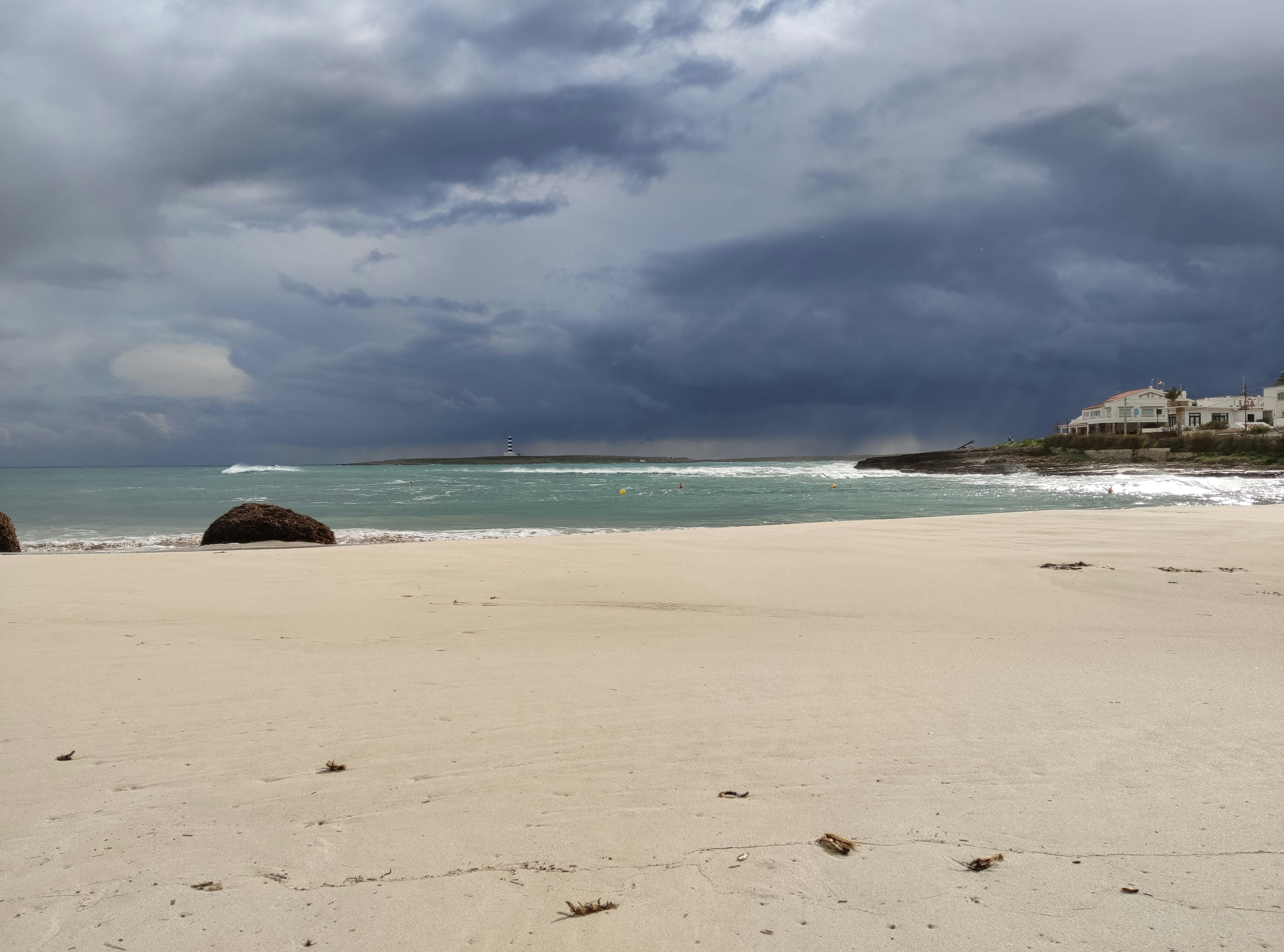 Turquoise waters and white sand beaches of the Outer Hebrides under a dramatic stormy sky, remote Scottish island photography