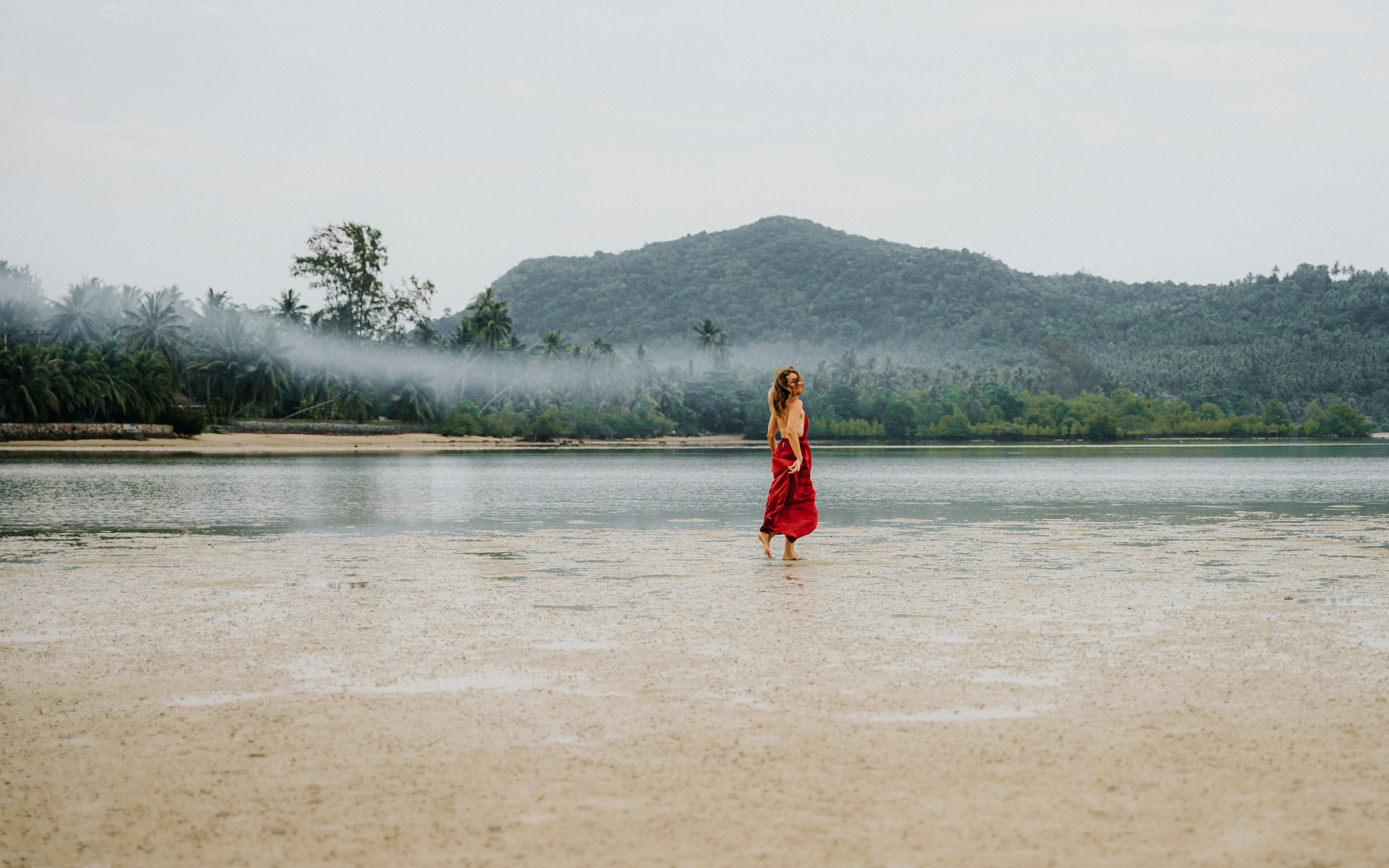 A woman in a red dress standing in the water photo – Free Koh phangan ...