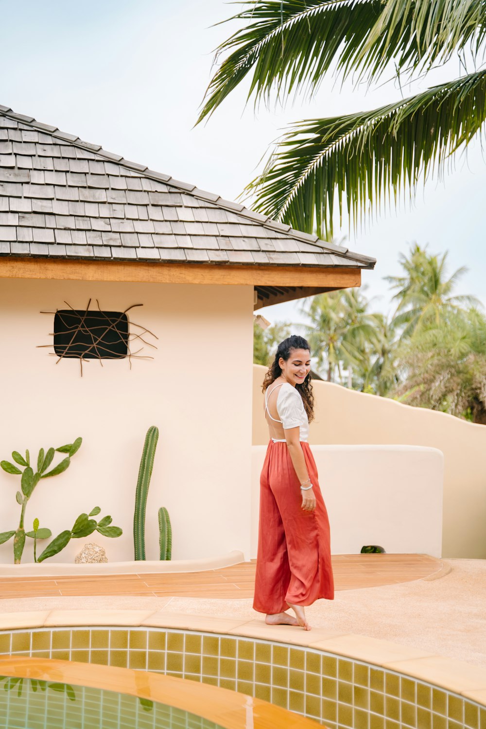 a woman standing in front of a pool