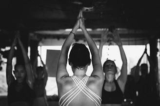 a group of women doing yoga in a room