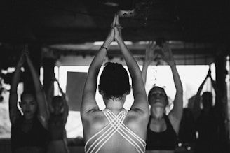 a group of women doing yoga in a room