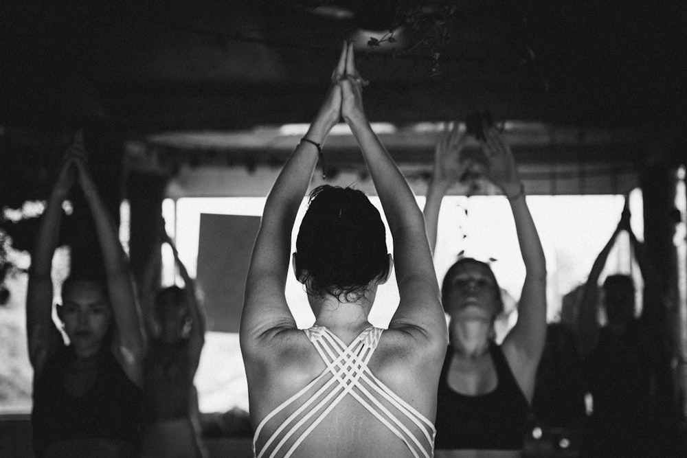 a group of women doing yoga in a room