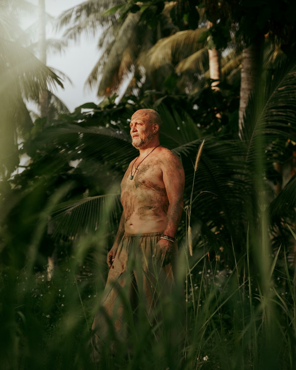 a man standing in the middle of a jungle