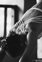 Hands gently tying a yoga strap made from organic cotton, highlighting the texture and craftsmanship.