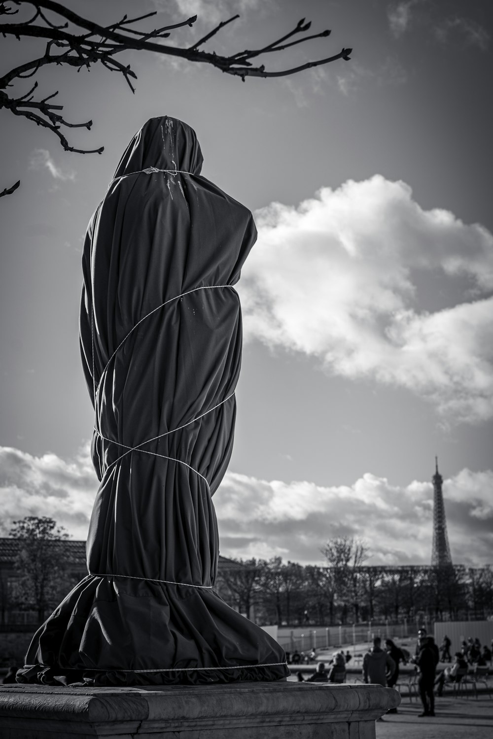 a black and white photo of a statue of a woman wrapped in a sheet