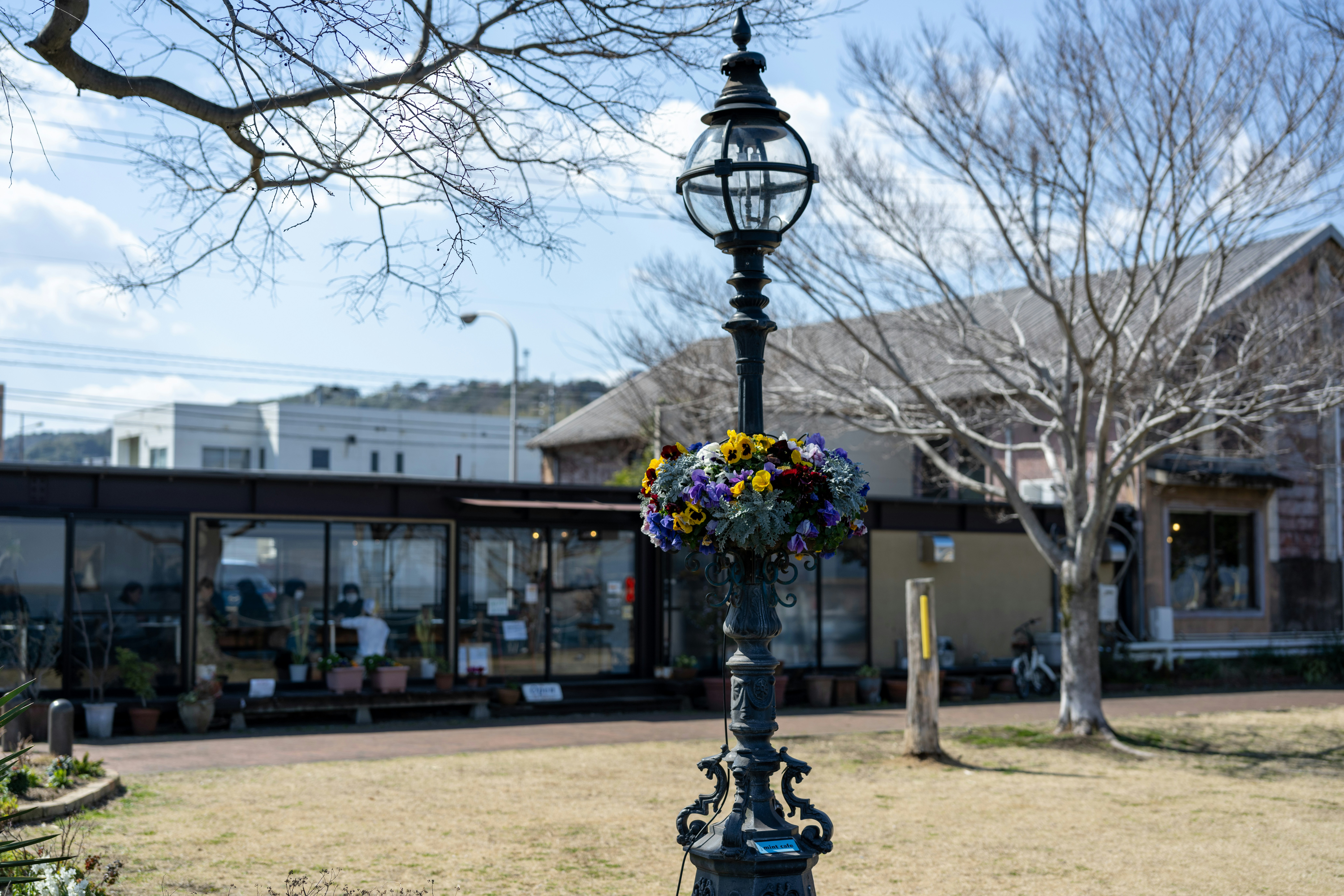 a lamp post with a bunch of flowers on it