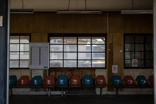 Waiting area near Bosan Road location, furnished with soft teal chairs and children’s books.