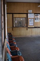 A safe space setup with comfortable seating and informational posters about emergency contacts and reporting mechanisms.