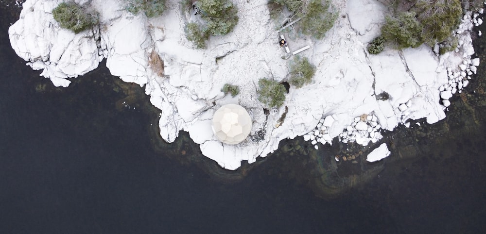 an aerial view of snow covered rocks and trees