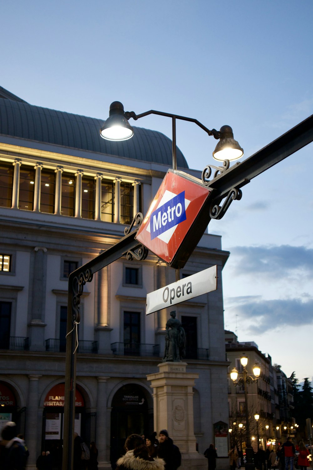 a metro sign hanging off the side of a pole