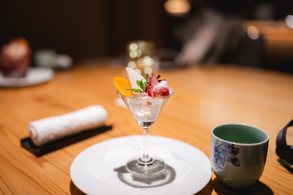 a small dessert in a martini glass on a table