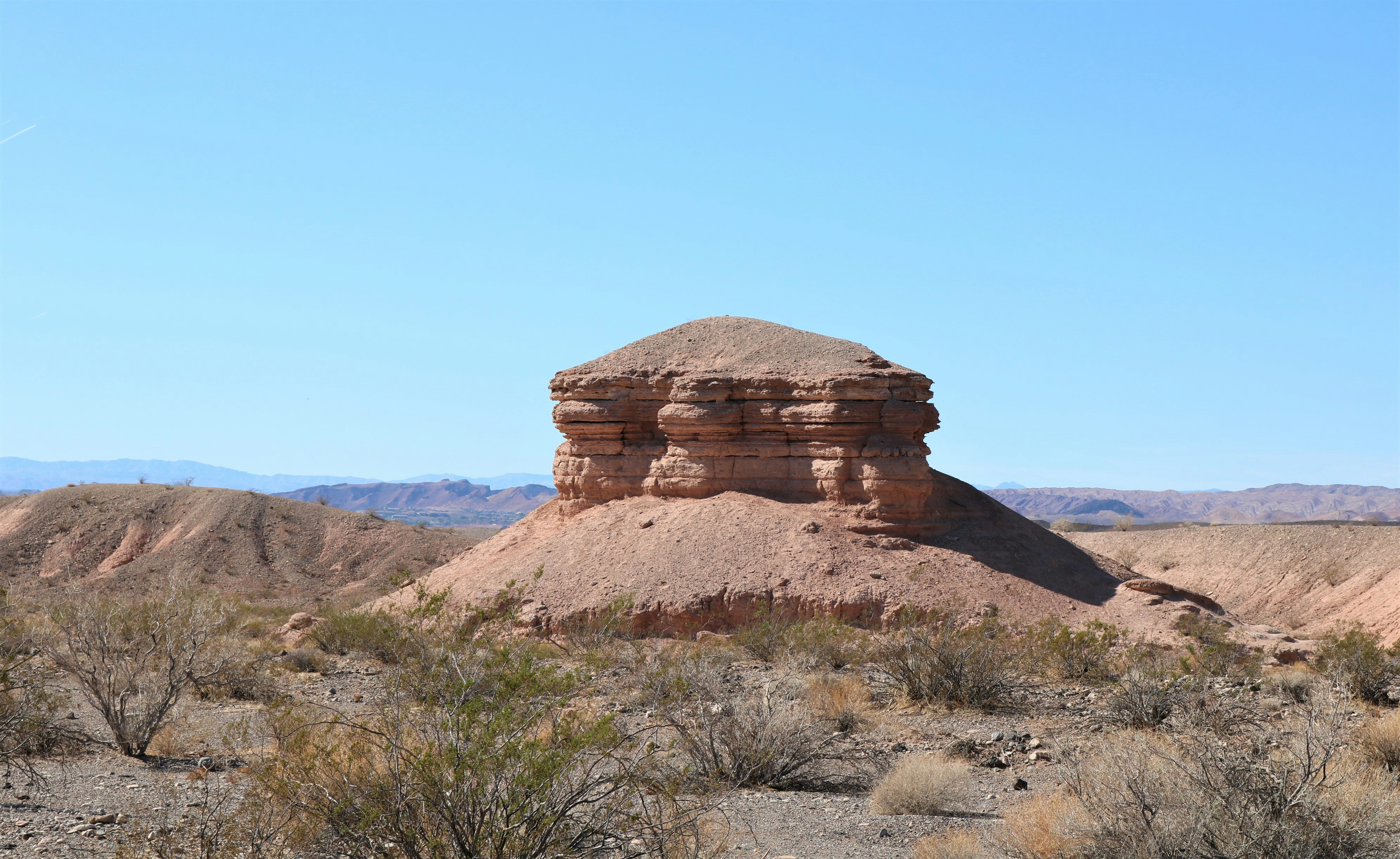 a rock formation in the middle of a desert