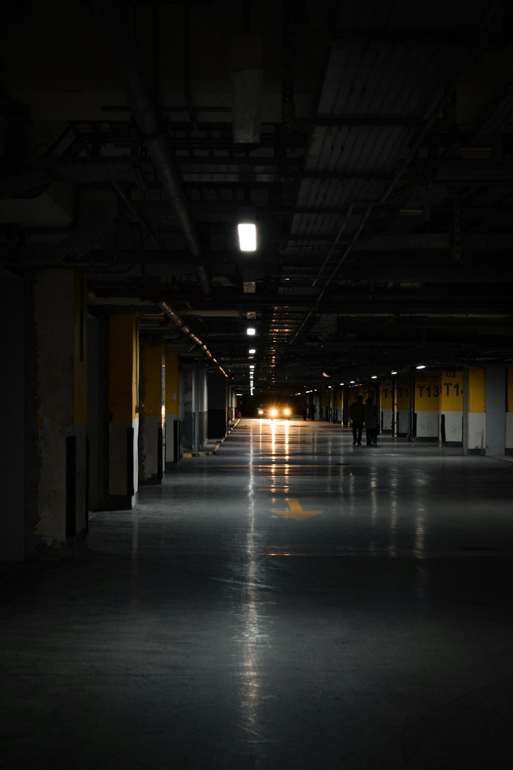 an empty parking garage with people walking in it