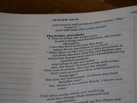 An open page of a book features text in a structured format, with headings and numbered lines. The text is focused and printed in a readable, serif font. The page number is visible at the top right corner.