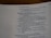 An open page of a book features text in a structured format, with headings and numbered lines. The text is focused and printed in a readable, serif font. The page number is visible at the top right corner.