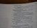 An open page of a book features text in a structured format, with headings and numbered lines. The text is focused and printed in a readable, serif font. The page number is visible at the top right corner.