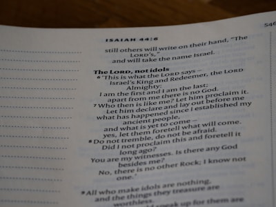 An open page of a book features text in a structured format, with headings and numbered lines. The text is focused and printed in a readable, serif font. The page number is visible at the top right corner.