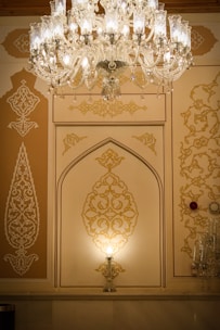 A beautifully lit Moroccan living room showcasing a golden chandelier from Baytnoor.