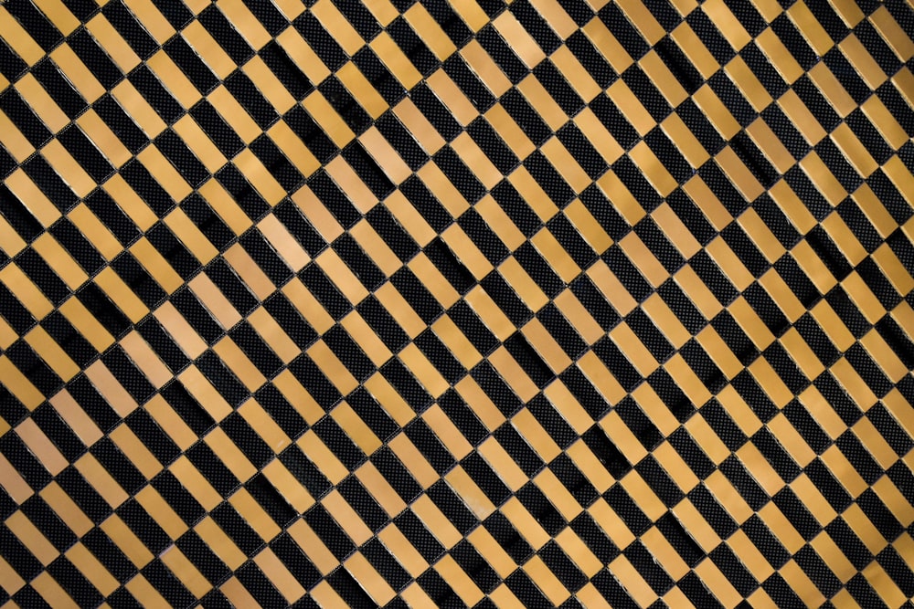 a black and gold checkered wallpaper with a diagonal pattern