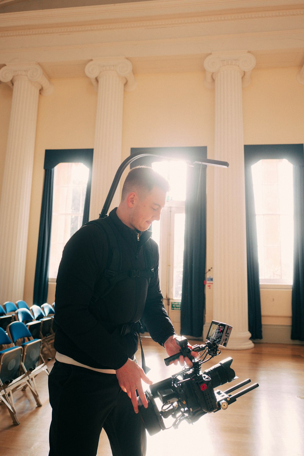 a man standing in a room with a camera