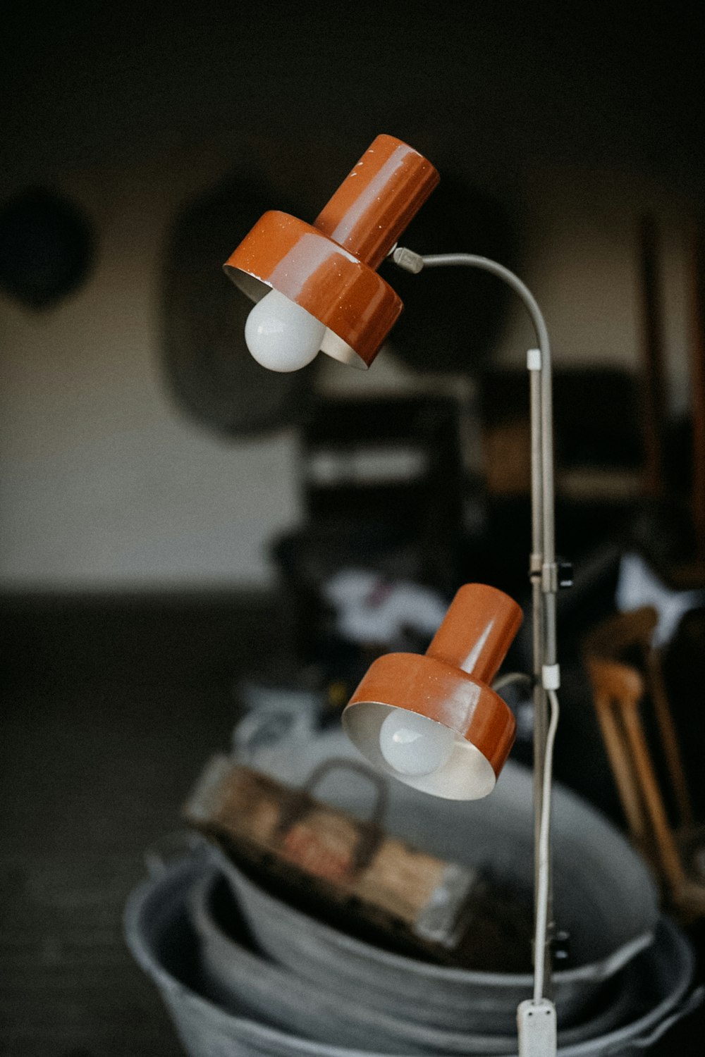 a pair of orange and white lamps on a table