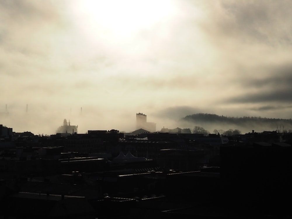 the sun is shining through the clouds over a city