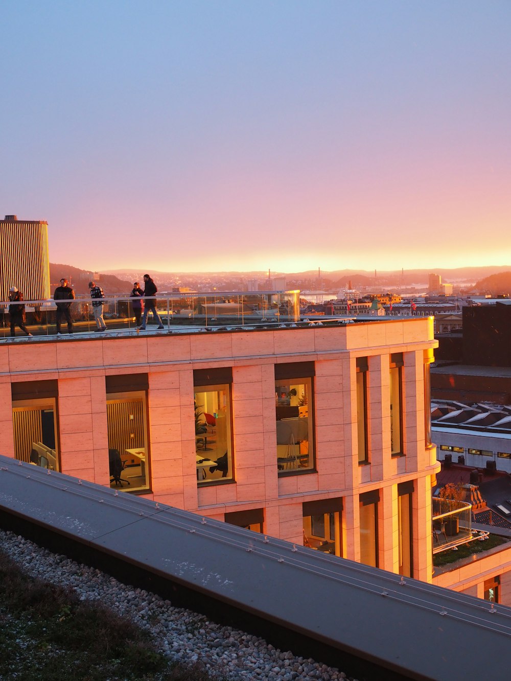 a couple of people standing on top of a building