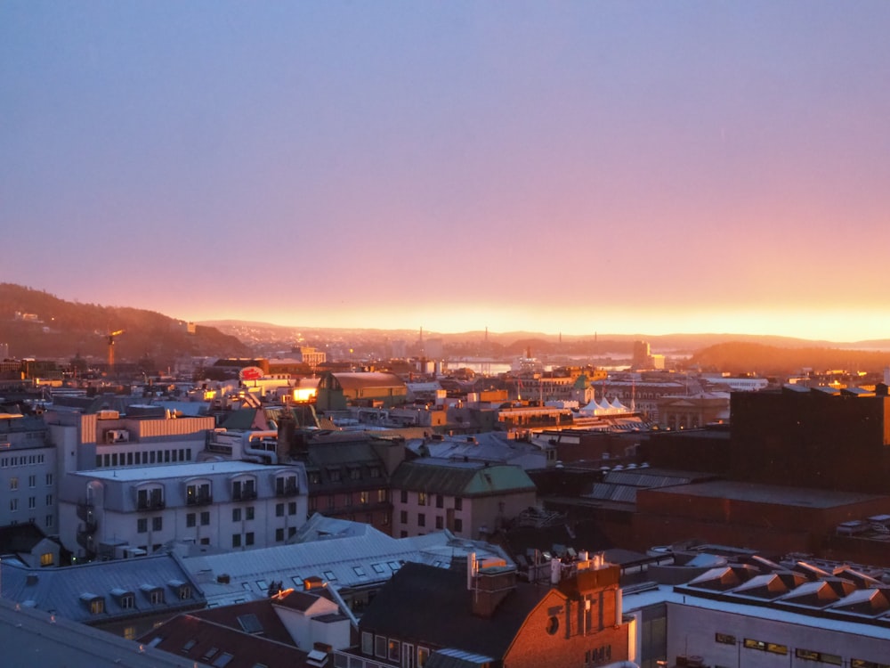 a view of a city at sunset from the top of a building