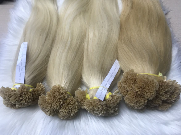 Close-up of glossy, perfectly styled hair extensions catching soft light.