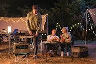 A lifestyle shot of friends enjoying a camping trip, all using daniela outdoor products.